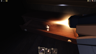 A battery inside a drawer in a dark room.